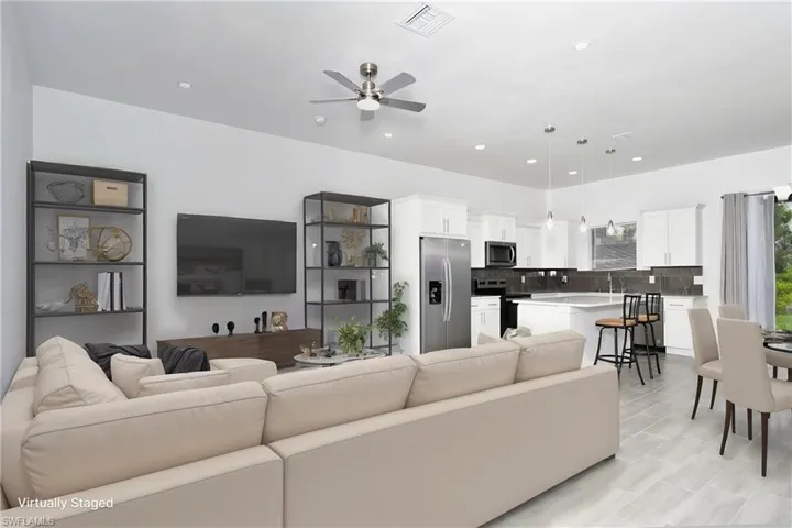 Living room featuring a ceiling fan and recessed lighting