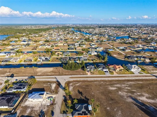 Aerial perspective of property's location with nearby suburban area and body of water