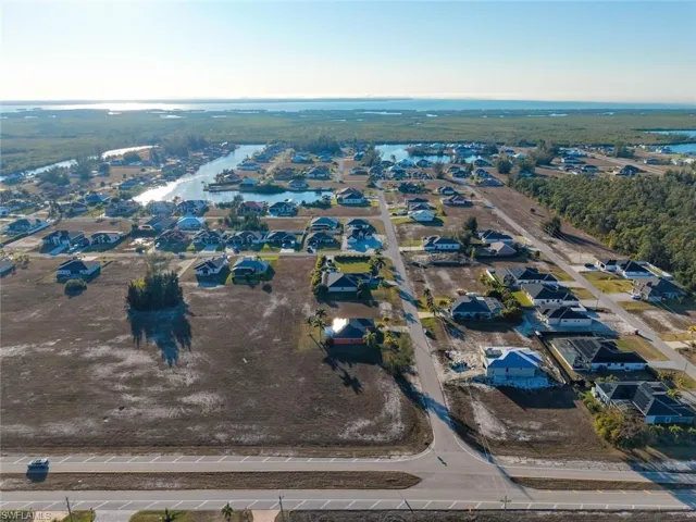 Aerial view of property's location featuring nearby suburban area and a large body of water