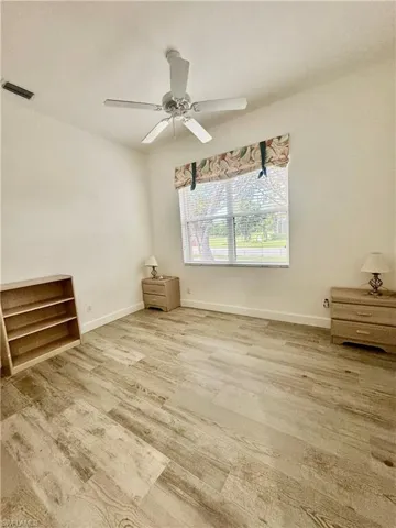 Unfurnished room featuring a ceiling fan and light wood-style floors