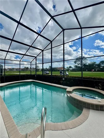 Relaxing pool / spa with a sunroom and a lanai