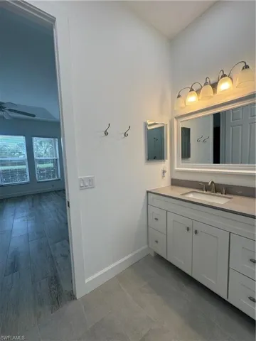 Bathroom with vanity and ceiling fan