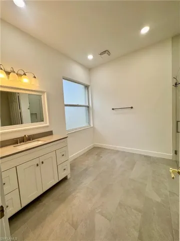 Full bath featuring vanity, a shower stall, and recessed lighting