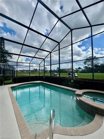 Combined pool / hot tub featuring a sunroom and a lanai