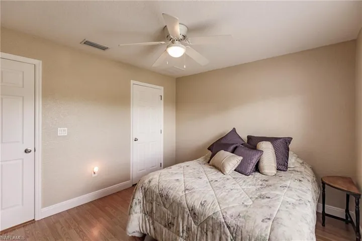 Bedroom with ceiling fan and wood-type flooring