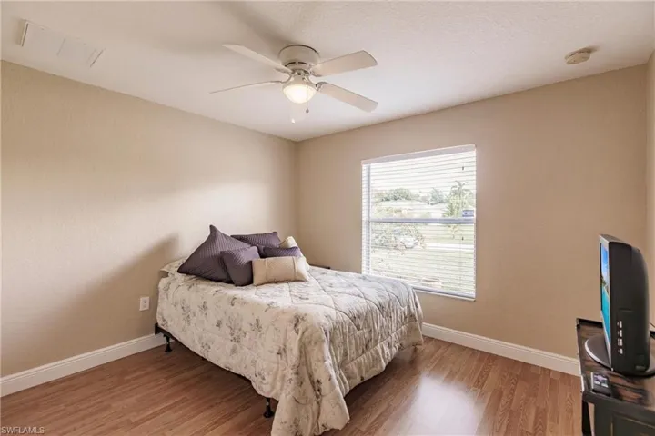 Bedroom featuring wood-type flooring and ceiling fan