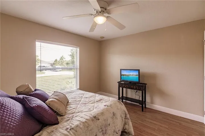 Bedroom featuring ceiling fan and hardwood / wood-style floors