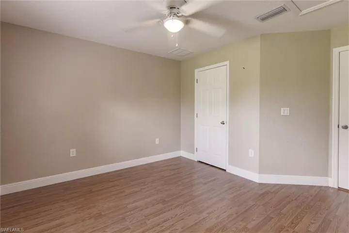Spare room featuring ceiling fan and hardwood / wood-style floors