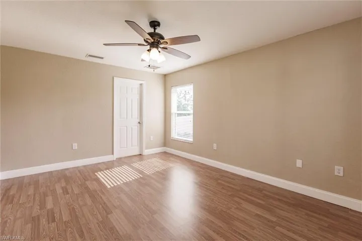 Spare room featuring hardwood / wood-style floors and ceiling fan