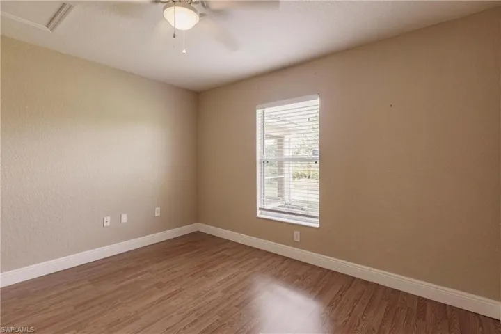 Spare room featuring ceiling fan and hardwood / wood-style floors