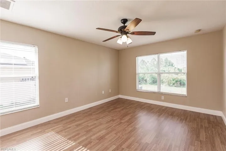 Unfurnished room with light hardwood / wood-style flooring and ceiling fan