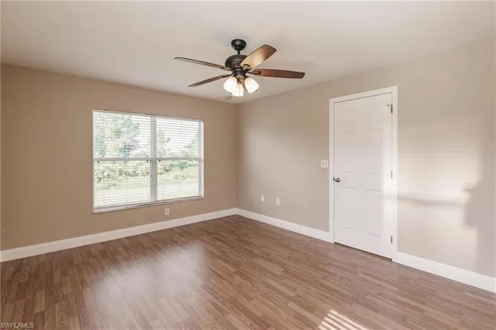Spare room with ceiling fan and hardwood / wood-style floors
