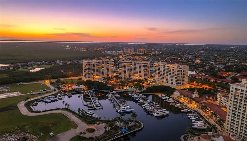 View of urban area with a large body of water and a marina