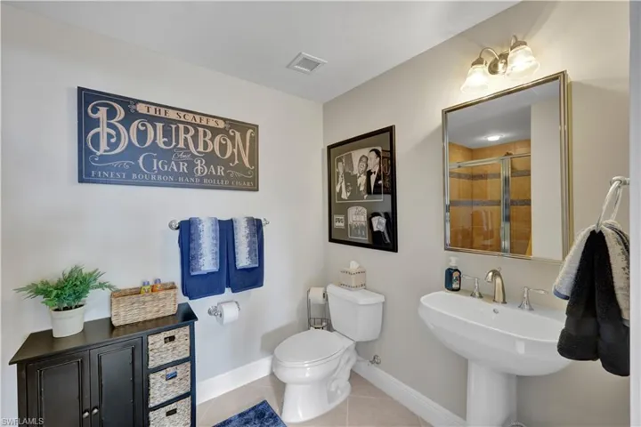 Bathroom featuring tile patterned flooring and a shower stall