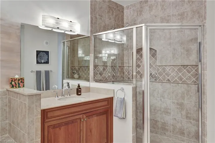 Bathroom featuring vanity and a shower stall