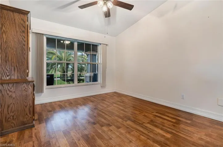 Spare room with baseboards, ceiling fan, and wood finished floors