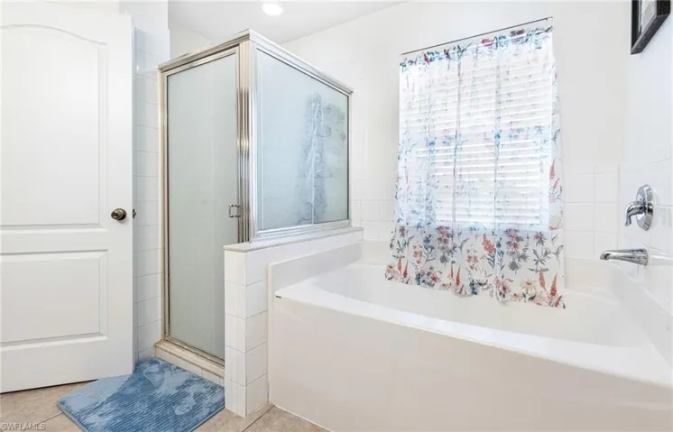 Bathroom featuring a garden tub, tile patterned flooring, a stall shower, and recessed lighting
