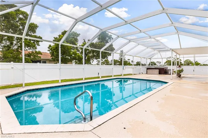 View of pool with a fenced in pool, a fenced backyard, a jacuzzi, and a patio area