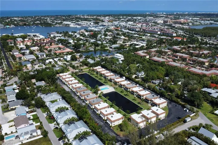 View of property location with a large body of water and nearby suburban area