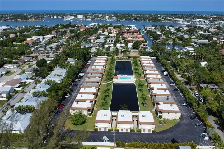 Aerial overview of property's location with nearby suburban area and a nearby body of water