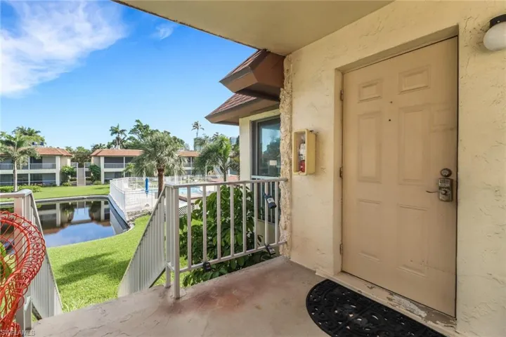 View of exterior entry with stucco siding and a balcony
