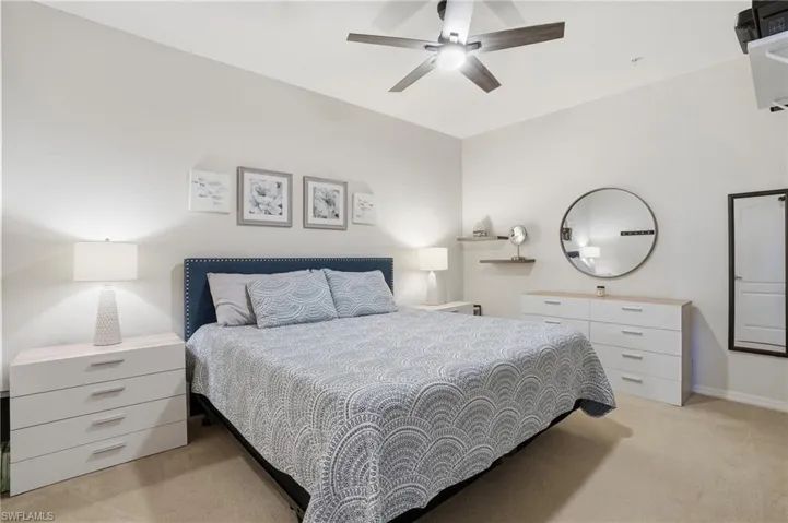 Bedroom featuring light colored carpet and a ceiling fan