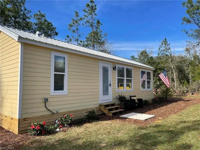Back of house featuring a lawn