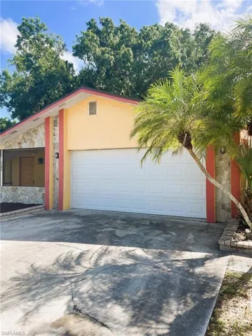 Garage featuring concrete driveway
