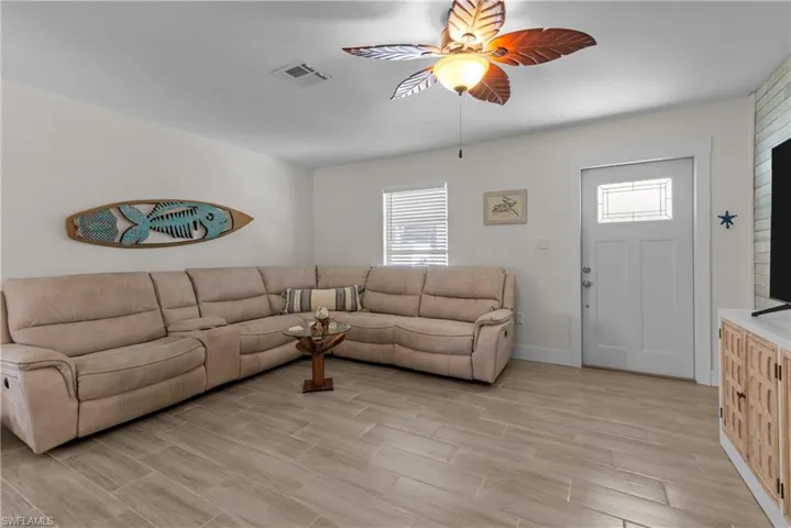 Living room featuring light hardwood / wood-style floors and ceiling fan