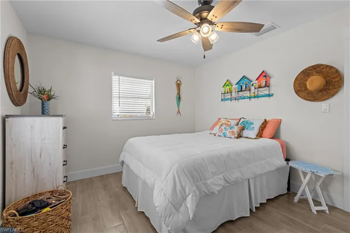 Bedroom with light hardwood / wood-style floors and ceiling fan