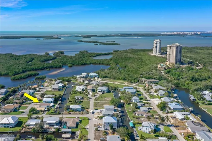 Birds eye view of property with a water view