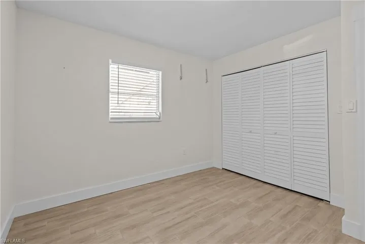 Unfurnished bedroom with a closet and light hardwood / wood-style flooring