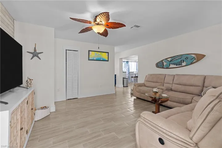 Living room featuring ceiling fan and light wood-type flooring
