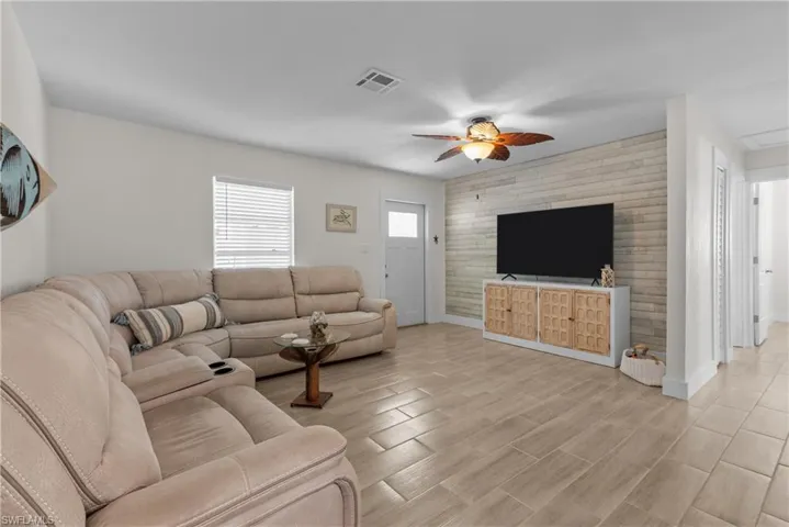 Living room with light wood-type flooring and ceiling fan