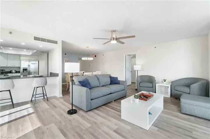 Living area with light wood-style floors, recessed lighting, and ceiling fan