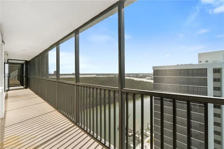 Balcony featuring a water view and a sunroom