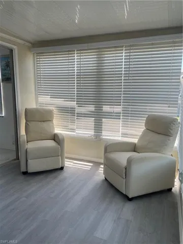 Sitting room featuring baseboards and wood finished floors