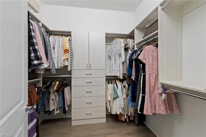 One of two walk in closets featuring California Closets