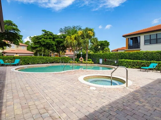 Community pool featuring a patio area and a community hot tub