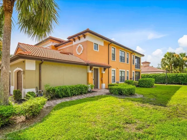 Mediterranean / spanish home with stucco siding and a front yard
