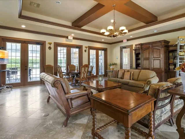 Tiled living area featuring french doors, recessed lighting, crown molding, beam ceiling, and coffered ceiling