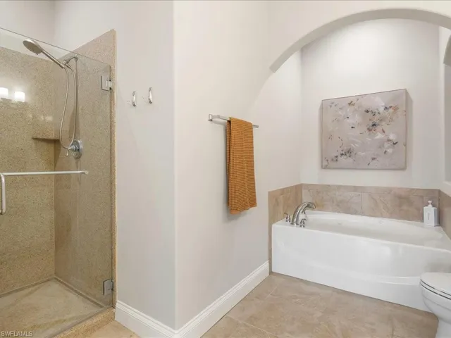 Full bathroom featuring a bath, a stall shower, and tile patterned floors