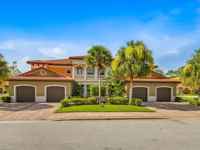 Mediterranean / spanish home featuring decorative driveway, stucco siding, an attached garage, a tile roof, and a front yard