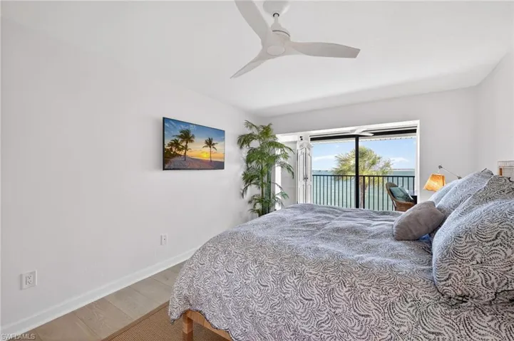 Primary Bedroom featuring light wood-finish flooring and a white ceiling fan