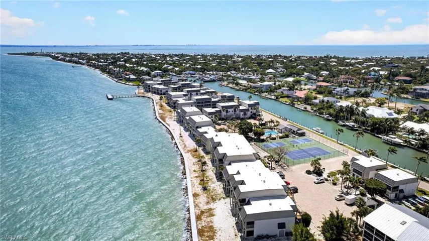 Waterfront community featuring multi-story residences with flat roofs and private balconies