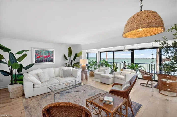 Open-concept living space featuring wood-finish flooring and extensive windows