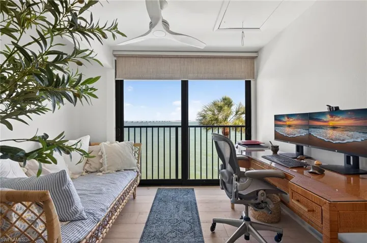 Room featuring wide plank wood-finish flooring and a built-in ceiling fan