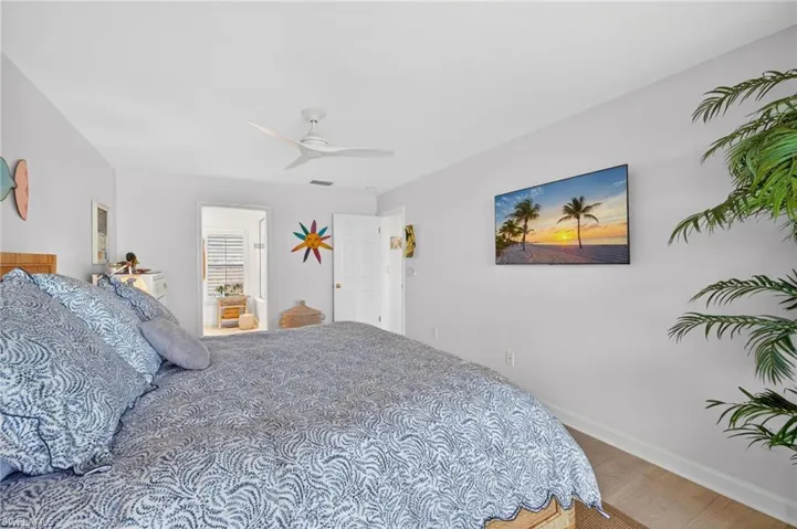 Primary Bedroom with light-toned walls and wood-finish flooring