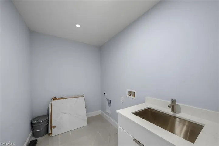 Laundry room with hookup for a washing machine, recessed lighting, hookup for an electric dryer, and light tile patterned floors