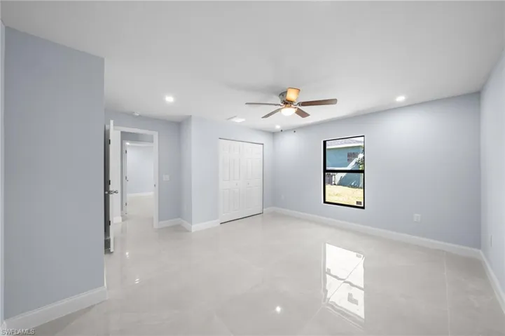 Unfurnished bedroom with recessed lighting, ceiling fan, a closet, and light tile patterned flooring